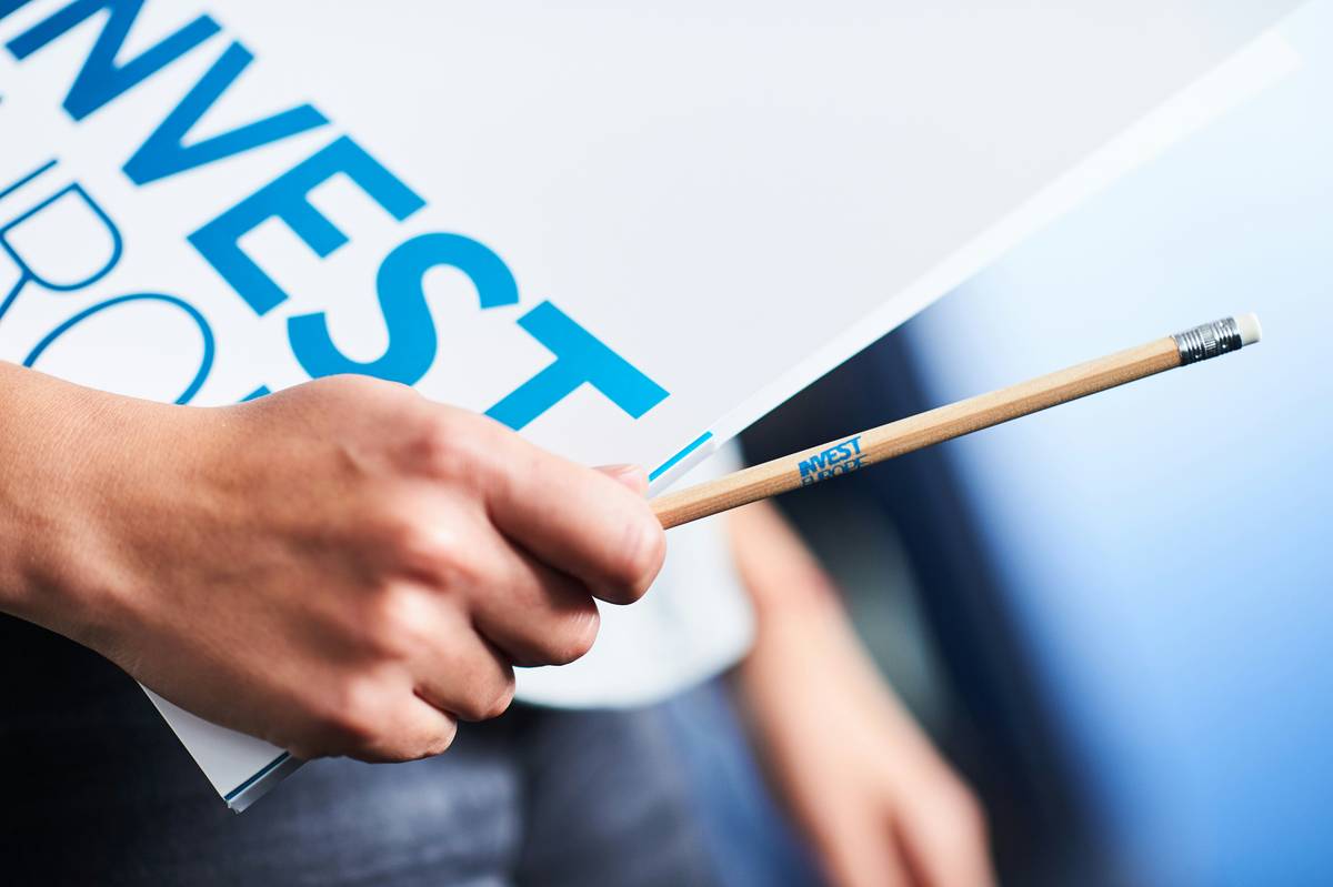 Student reviewing certified financial planner course materials focused on estate trusts and tax strategies