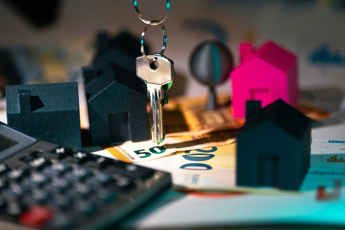 what is estate management: illustration showing a portfolio manager reviewing property deeds, financial statements, and legal documents on a desk